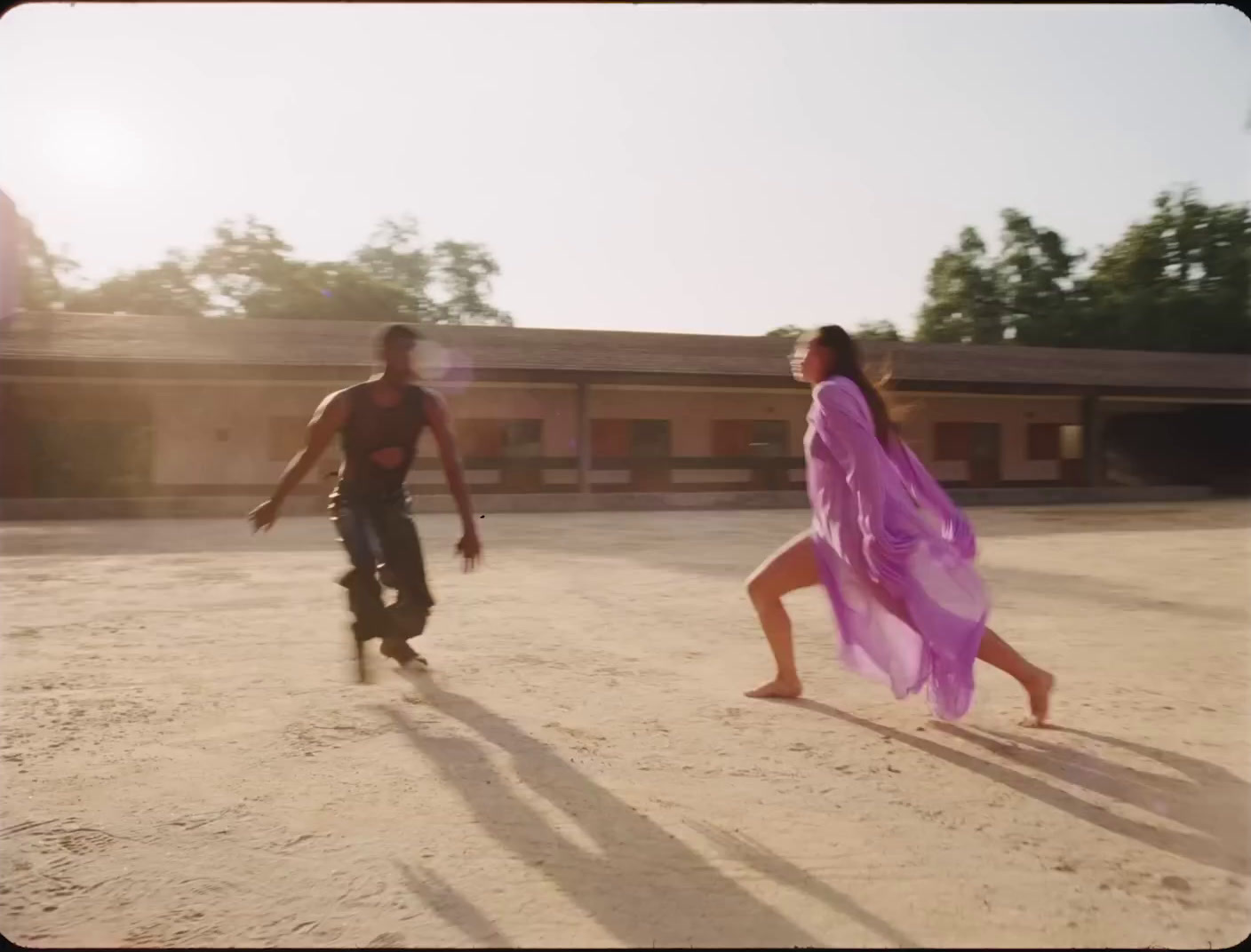 a man and a woman are playing with a frisbee