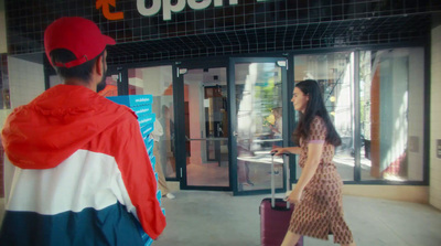 a man and a woman walking through an airport