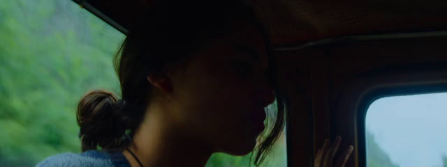 a woman looking out the window of a vehicle