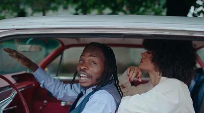 a man and a woman sitting in a car