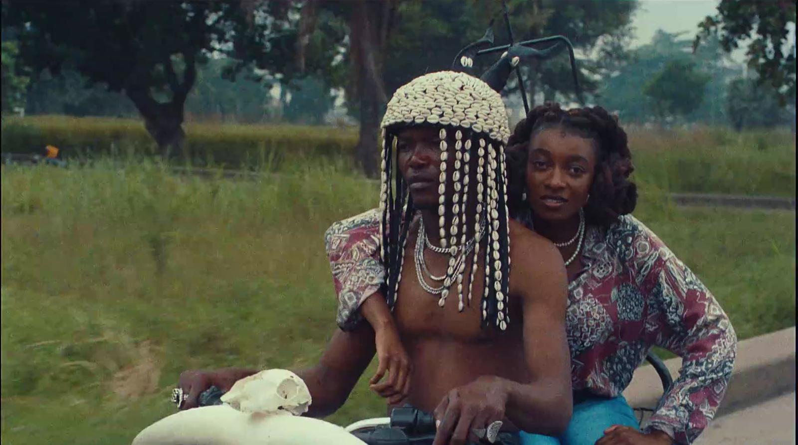 a man and a woman riding a motorcycle