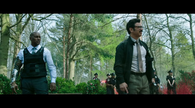 a group of men standing next to each other in a forest