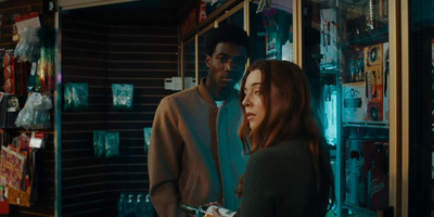 a man and a woman standing in front of a store