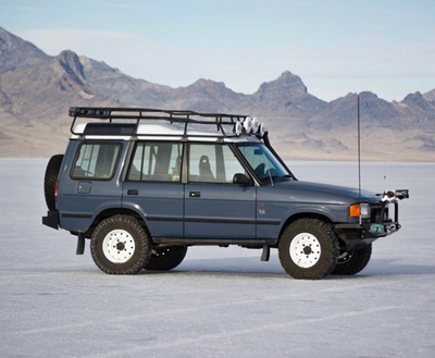 a vehicle with a rack on top of it in the desert