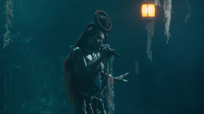 a woman with long hair standing in the dark