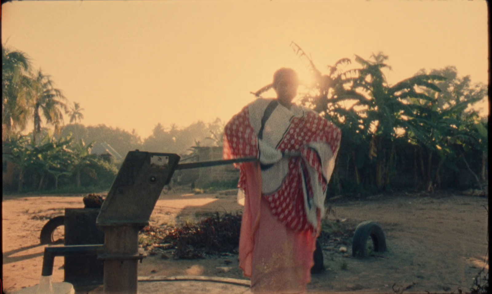 a man in a red and white robe standing next to a machine