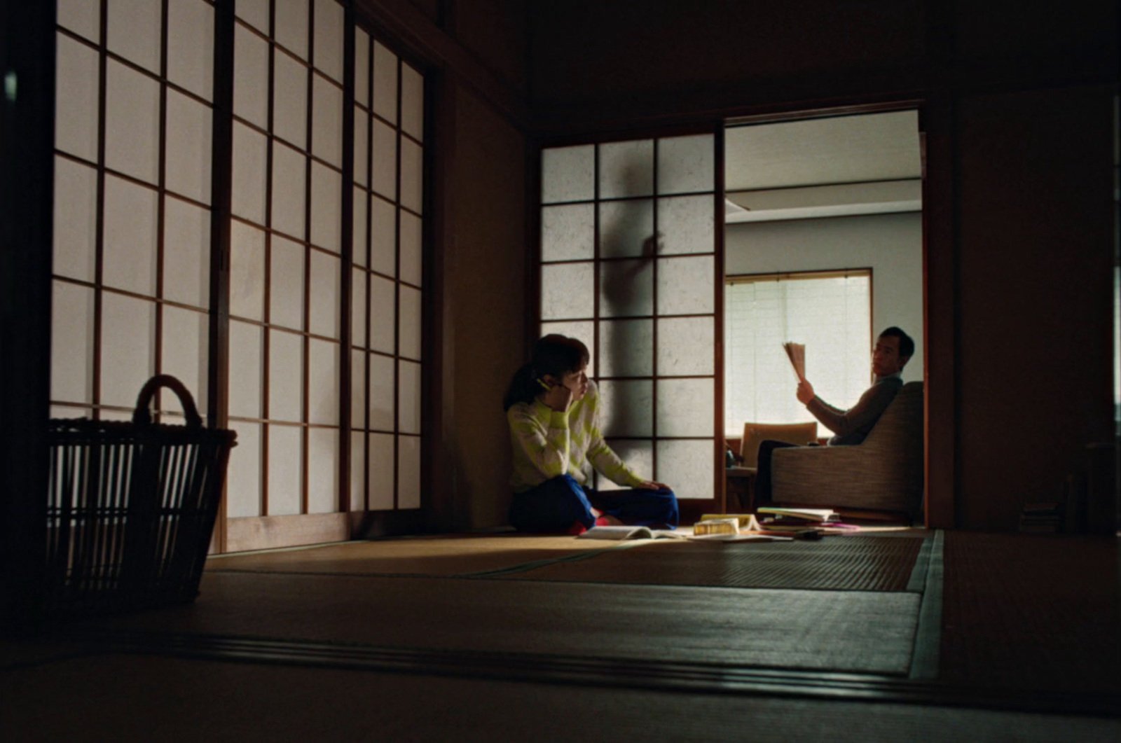 a woman sitting on the floor in front of a window