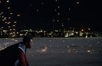 a man walking down a street at night