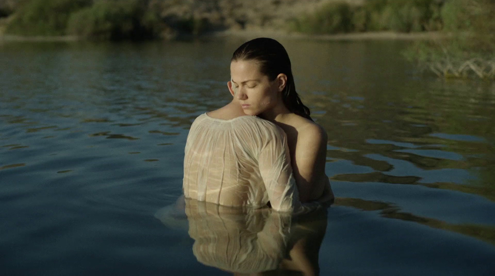 a woman in the water with her eyes closed