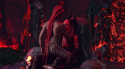 a man with red hair sitting on a rock next to a demon