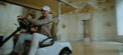 a couple of men standing next to a white car