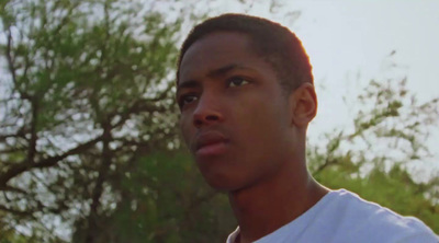 a close up of a person with trees in the background