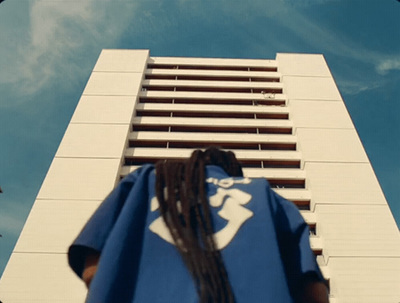 a woman standing in front of a tall building