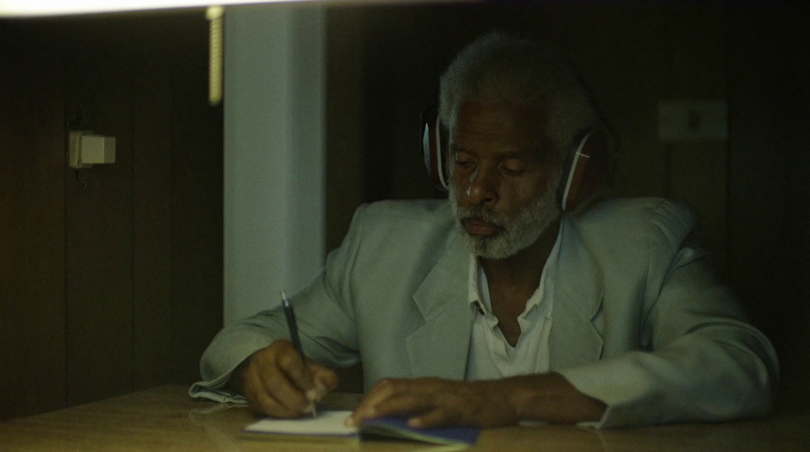 a man sitting at a table with headphones on