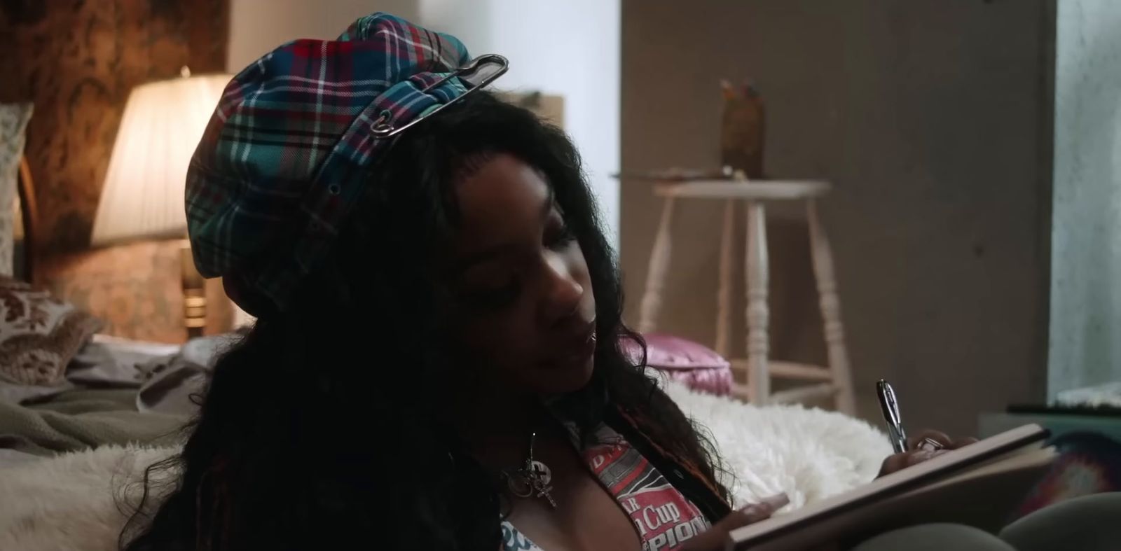 a woman sitting on a bed reading a book