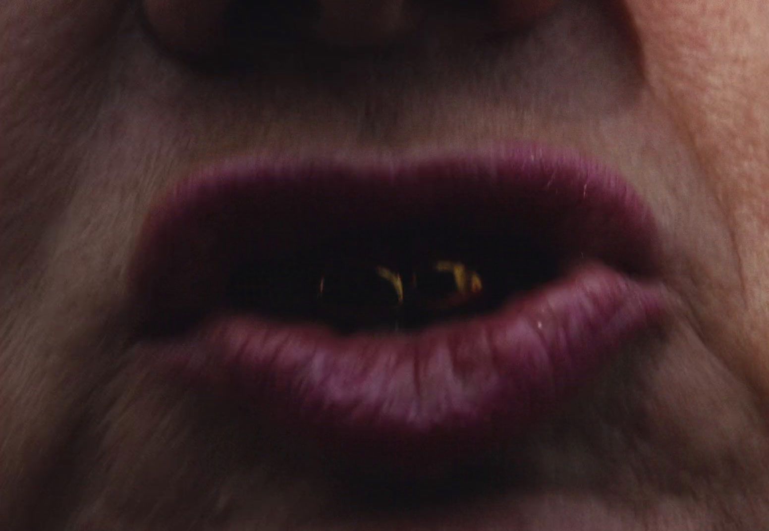 a close up of a woman's lips with a cat's eye