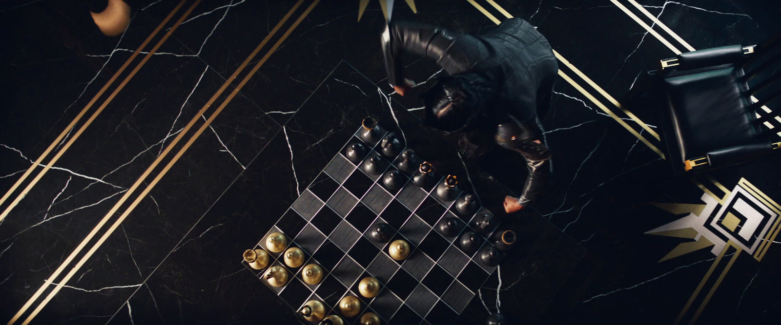 a man playing a game of chess on a marble table