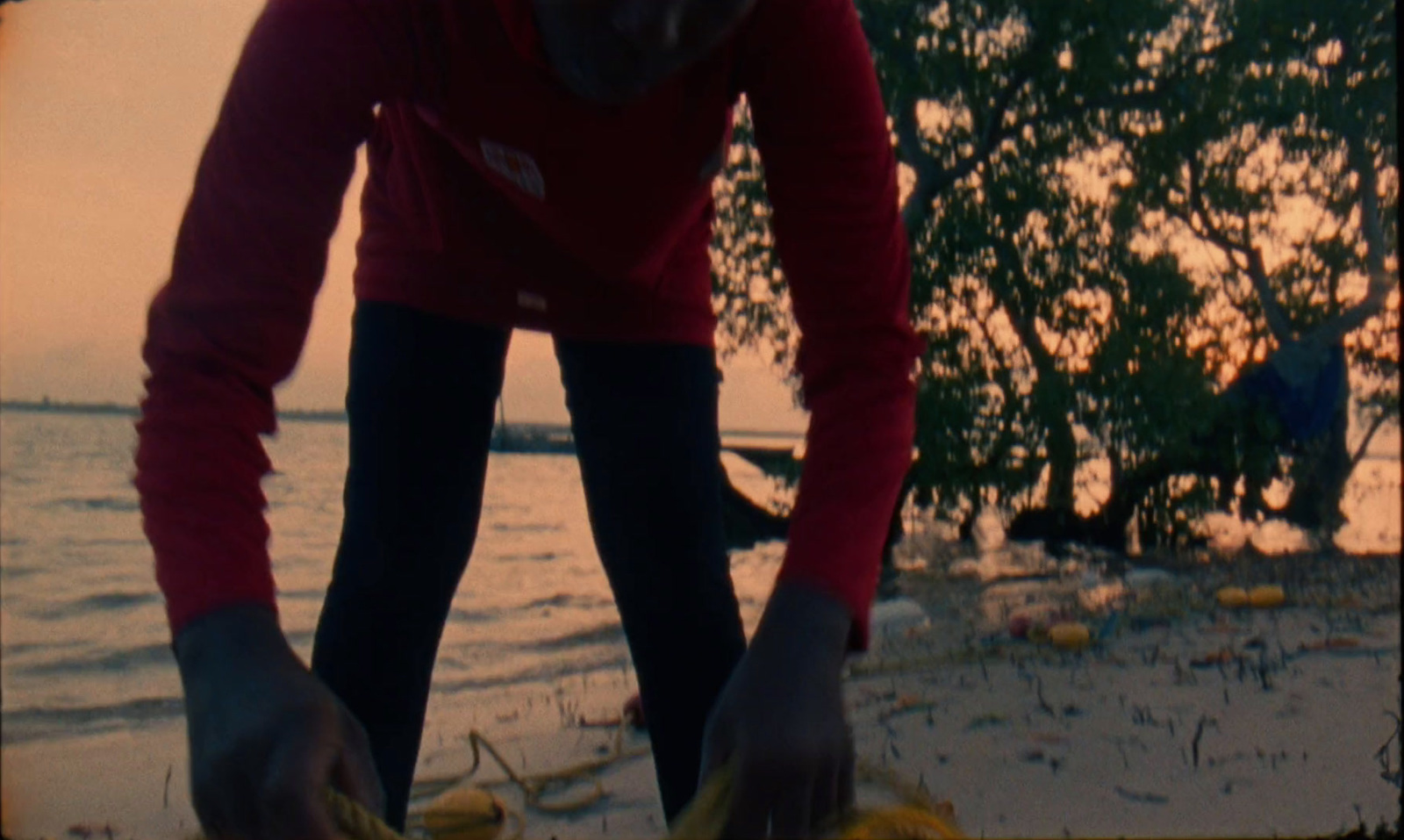 a man in a red shirt holding a yellow object