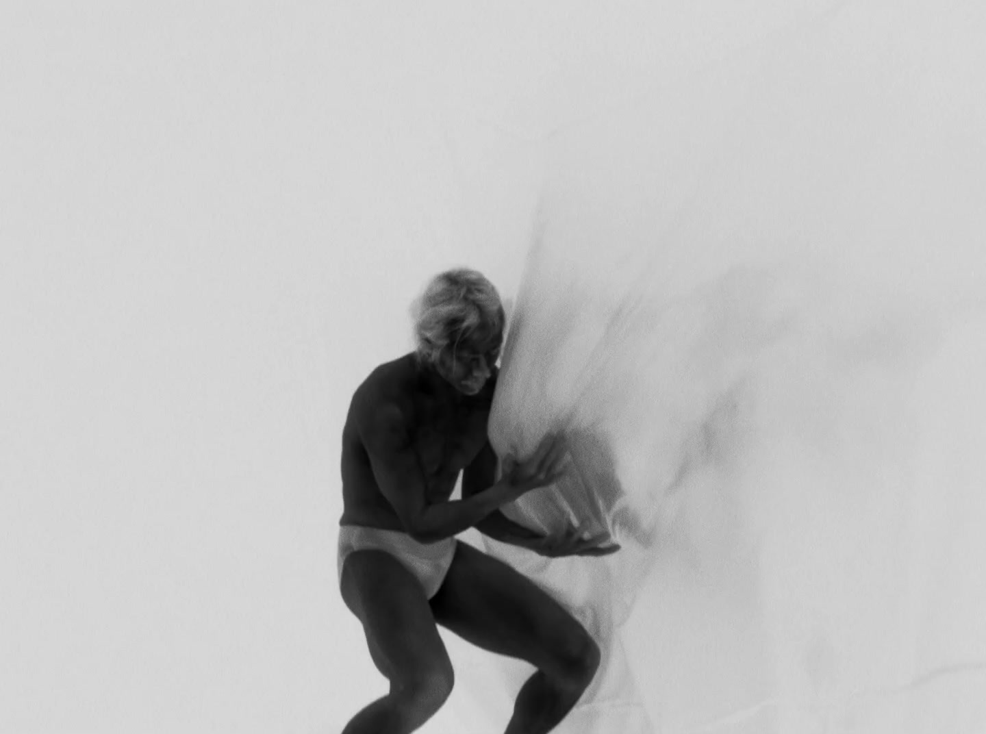 a man in a bathing suit standing on a surfboard