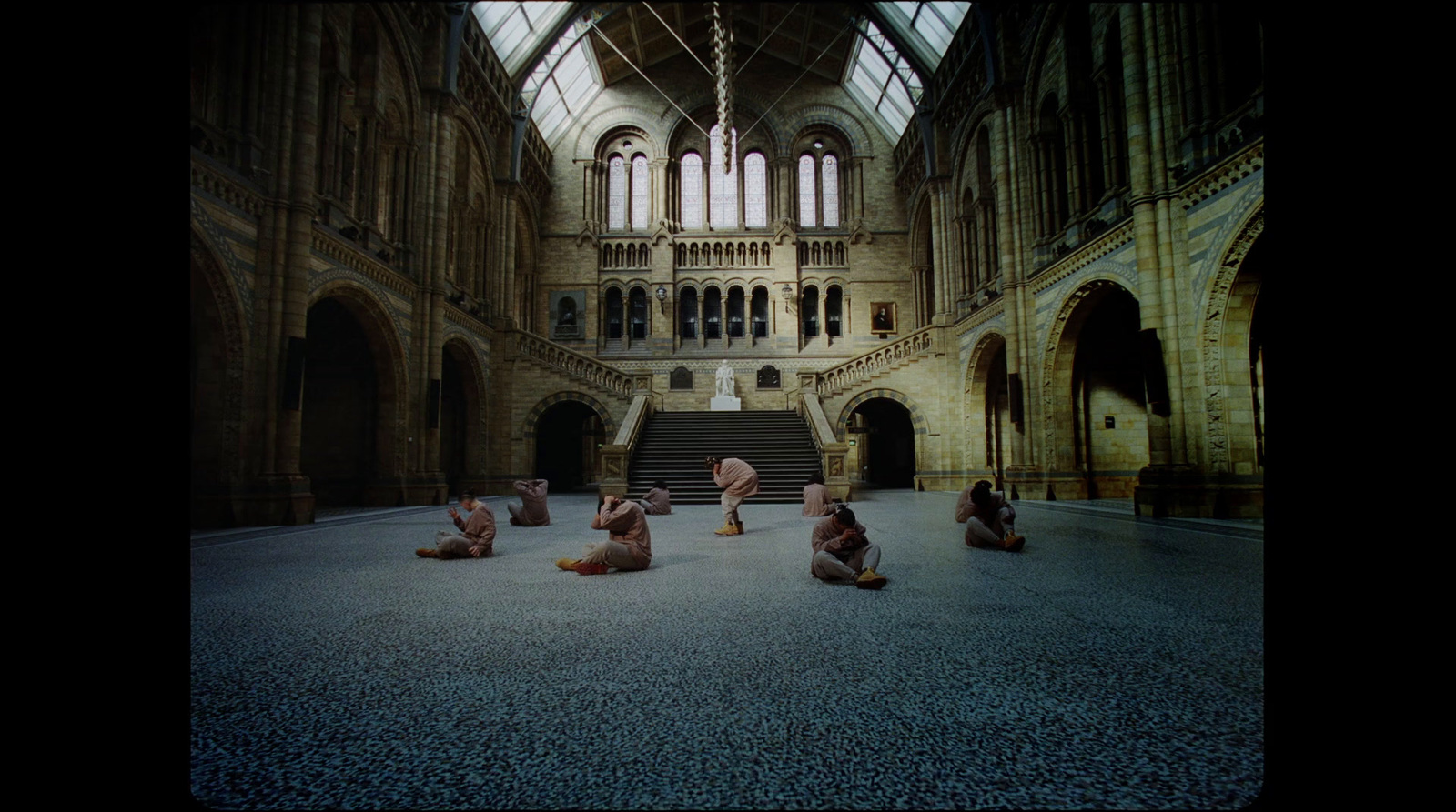 a group of people sitting on the ground in a building