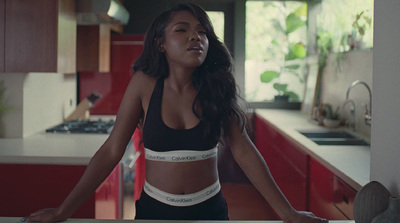 a woman standing in a kitchen next to a counter