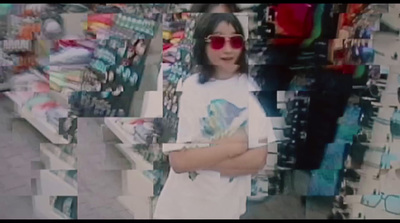 a woman wearing sunglasses standing in front of a store