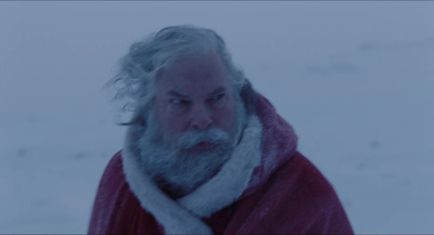 a man with a beard wearing a red coat