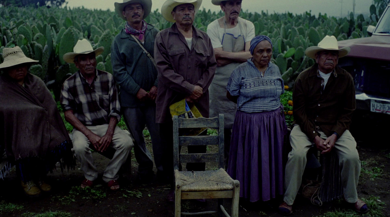 a group of people standing next to each other in a field