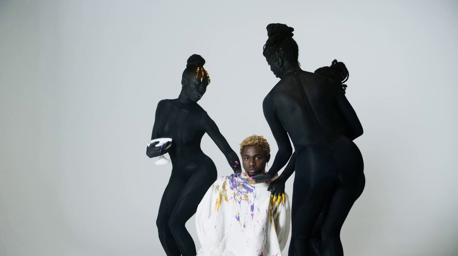 three women in black bodysuits standing next to each other