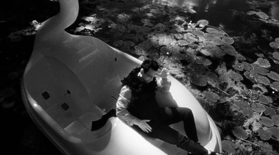 a man sitting in a boat on a body of water