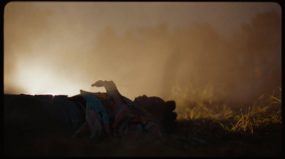 a person laying on the ground in the grass