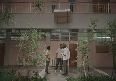 a couple of people standing in front of a building