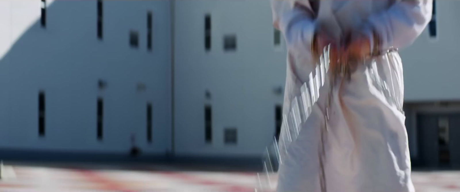 a blurry photo of a person walking in front of a building