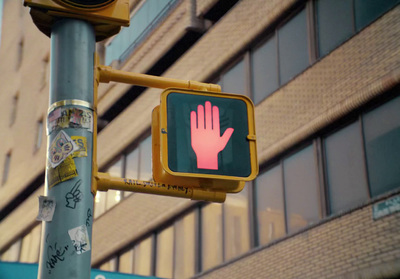 a traffic light with a hand painted on it