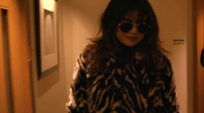 a woman wearing sunglasses and a fur coat