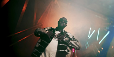 a man standing in front of a stage holding a microphone