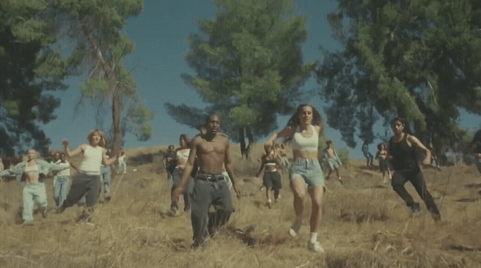 a group of people running through a field