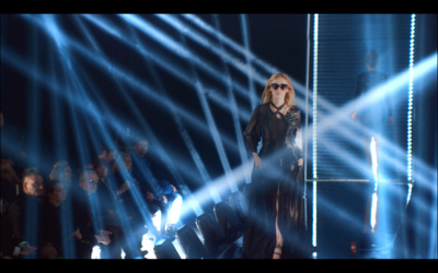 a woman standing on a stage in front of a crowd