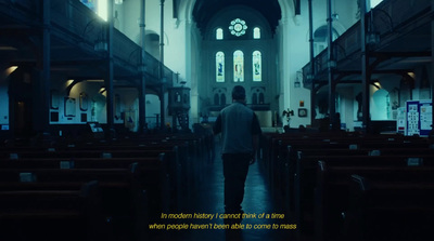 a man walking down the aisle of a church