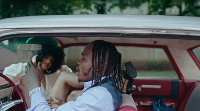 a man and a woman sitting in a car