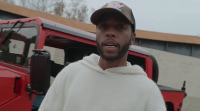 a man standing in front of a red truck