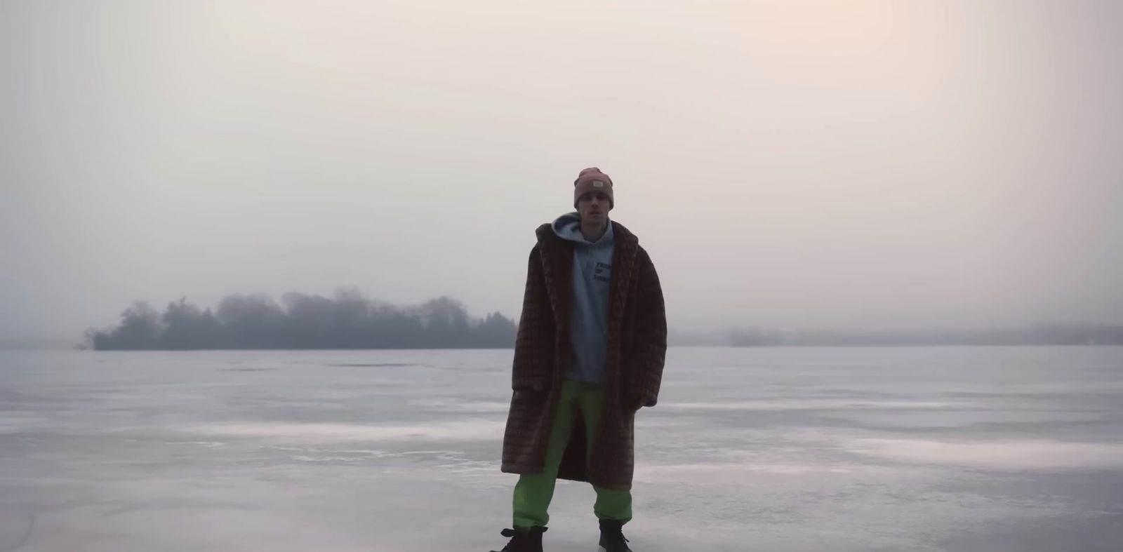 a man standing on top of a frozen lake