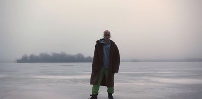 a man standing on top of a frozen lake