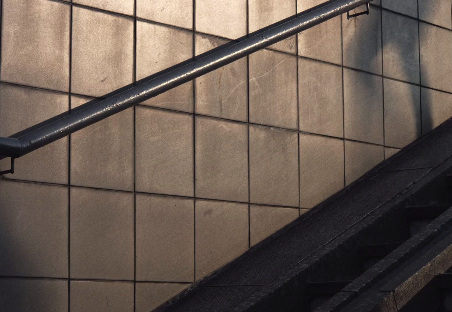 a close up of a metal hand rail on a wall