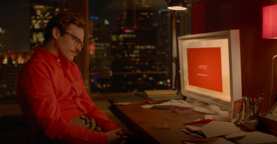 a man sitting at a desk in front of a computer