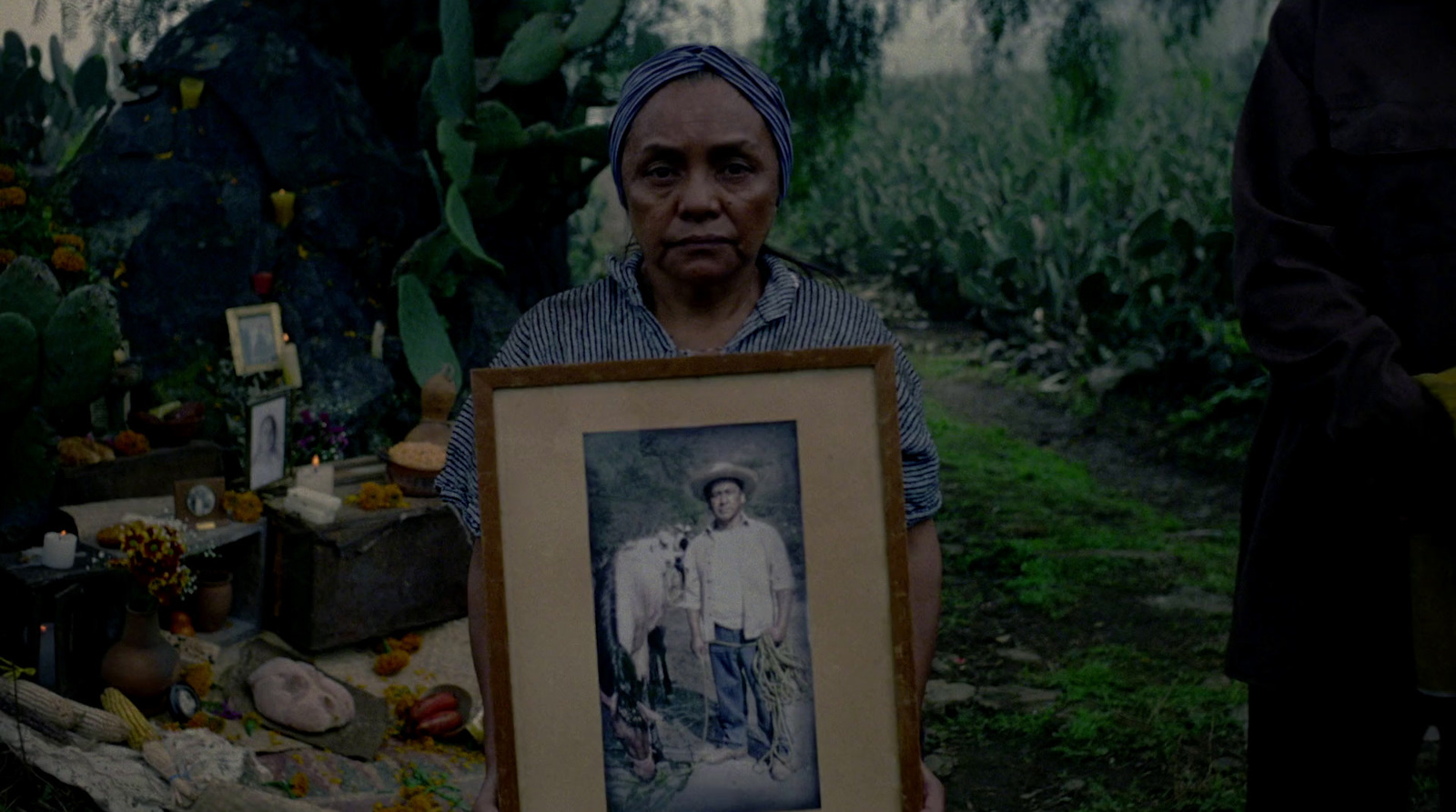 a woman holding up a picture of a man