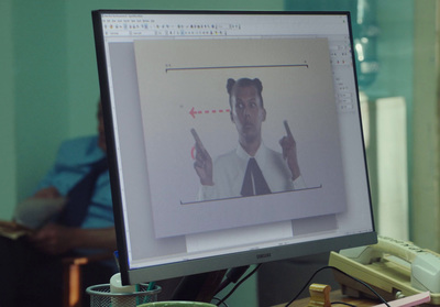 a computer screen with a man holding a cell phone