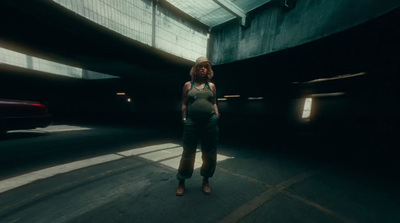 a woman standing in the middle of a tunnel