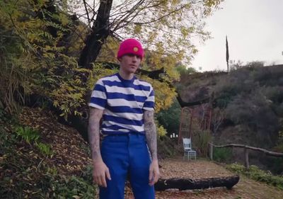 a man in a striped shirt and pink hat