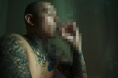 a man with tattoos on his chest and arm